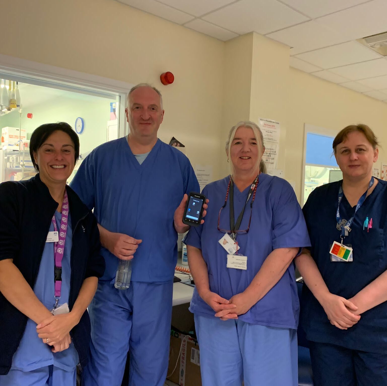 Some of the team at NHS Lothian's Interventional Radiology Team, smile together for the camera. Four people pictured. The team were the first team in Scotland to implement Scan for Safety's Point of Care